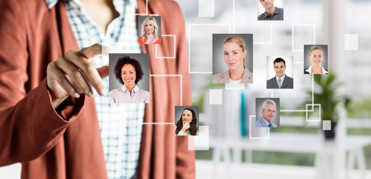 Businesswoman using cloud-based HR software interface to manage employee profiles and digital workforce remotely.