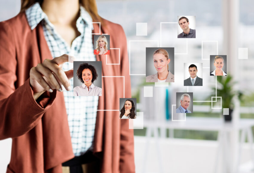 Businesswoman using cloud-based HR software interface to manage employee profiles and digital workforce remotely.