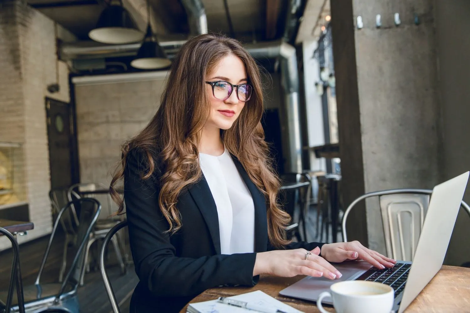Professional employee using an employee self service portal on a laptop to manage HR tasks
